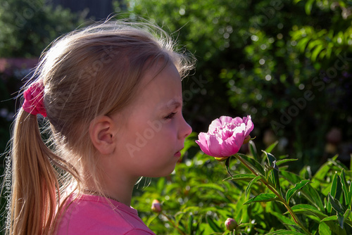 little girl smelling flowers