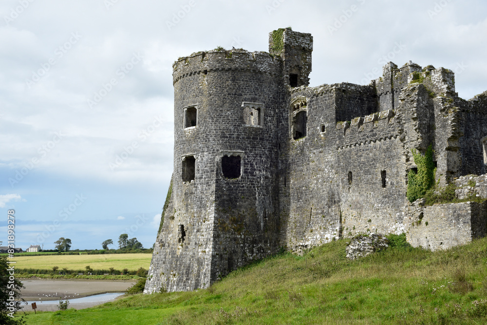 Carew Castle in Wales exterior view over the nearby river is an historic point of interest for tourists to visit Carew Castle in Wales exterior view over the nearby river is an historic point of interest for tourists to visit