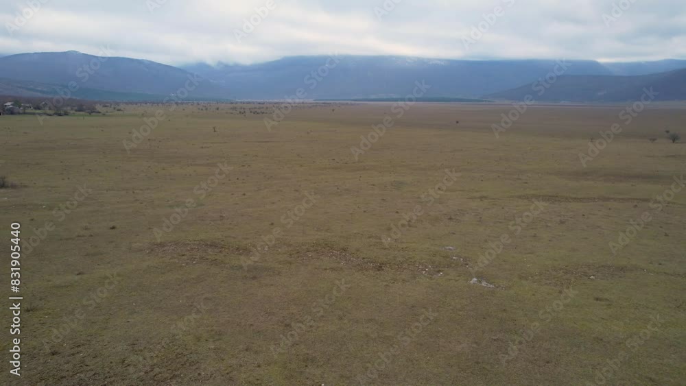 A beautiful landscape drone video of an empty field with a road in Croatia region Lika in Europe A beautiful landscape drone video of an empty field with a road in Croatia region Lika in Europe