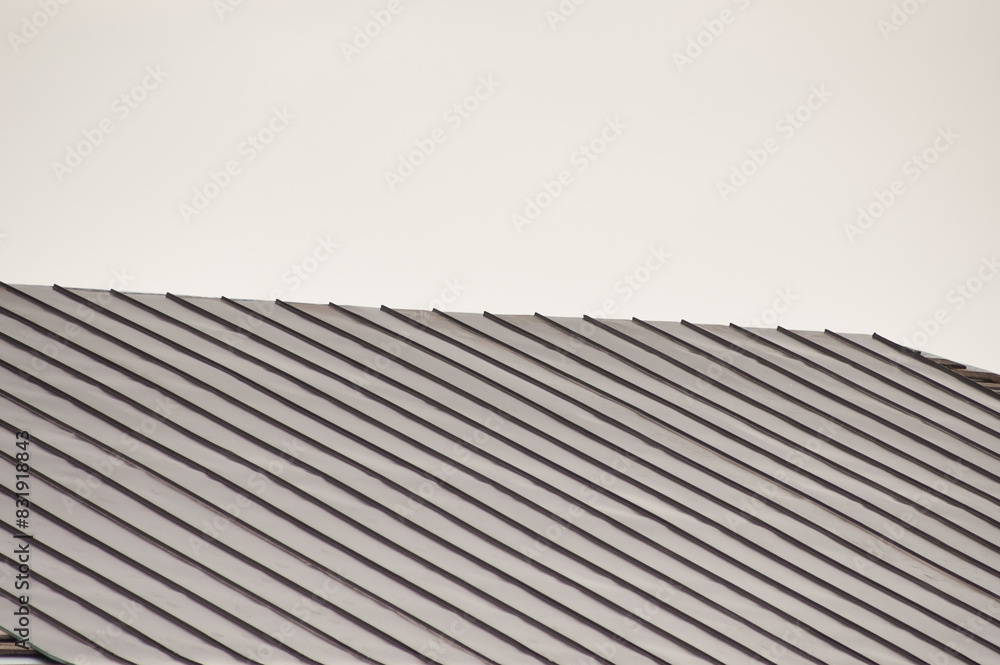 new roof of a building against a background of gray sky new roof of a building against a background of gray sky