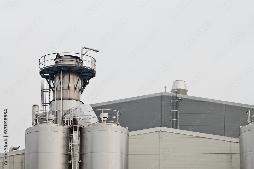 elements of a dairy factory against a background of gray sky elements of a dairy factory against a background of gray sky