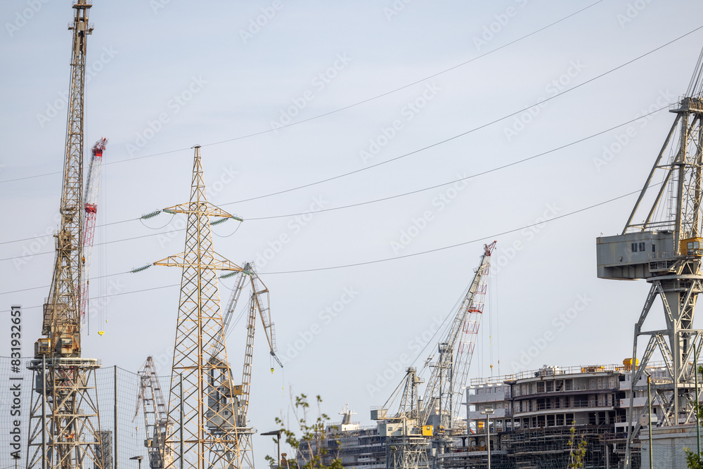 Construction site with cranes and power lines Construction site with cranes and power lines