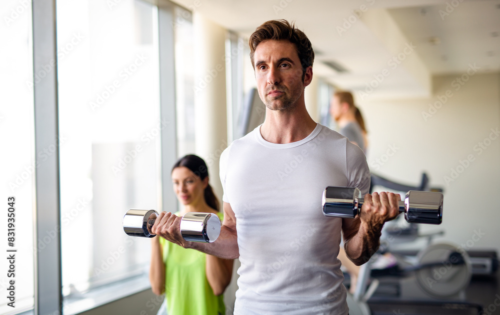 Group of young people doing exercises in gym to stay healthy. Sport gym workout friends concept. Group of young people doing exercises in gym to stay healthy. Sport gym workout friends concept.