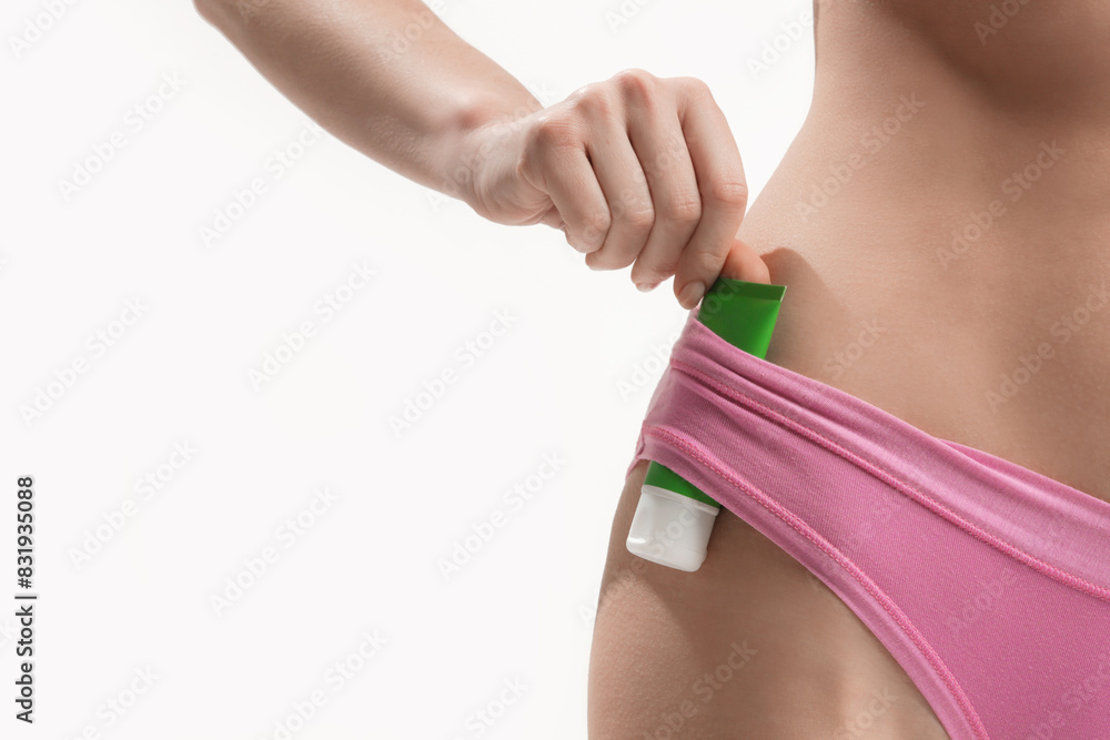 Close up of woman holding bottle with skincare cosmetic product Close up of woman holding bottle with skincare cosmetic product