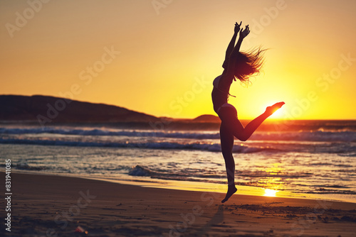 Tableau sur toile Woman, sunset and jump silhouette on beach, horizon and holistic wellness for energy in nature