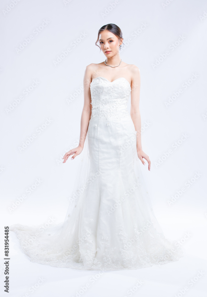 Asian young beautiful female portrait attractive model of bride wearing fashion wedding dress, luxury delight make-up, hairstyle, standing looking camera isolated white background studio indoor photo Asian young beautiful female portrait attractive model of bride wearing fashion wedding dress, luxury delight make-up, hairstyle, standing looking camera isolated white background studio indoor photo