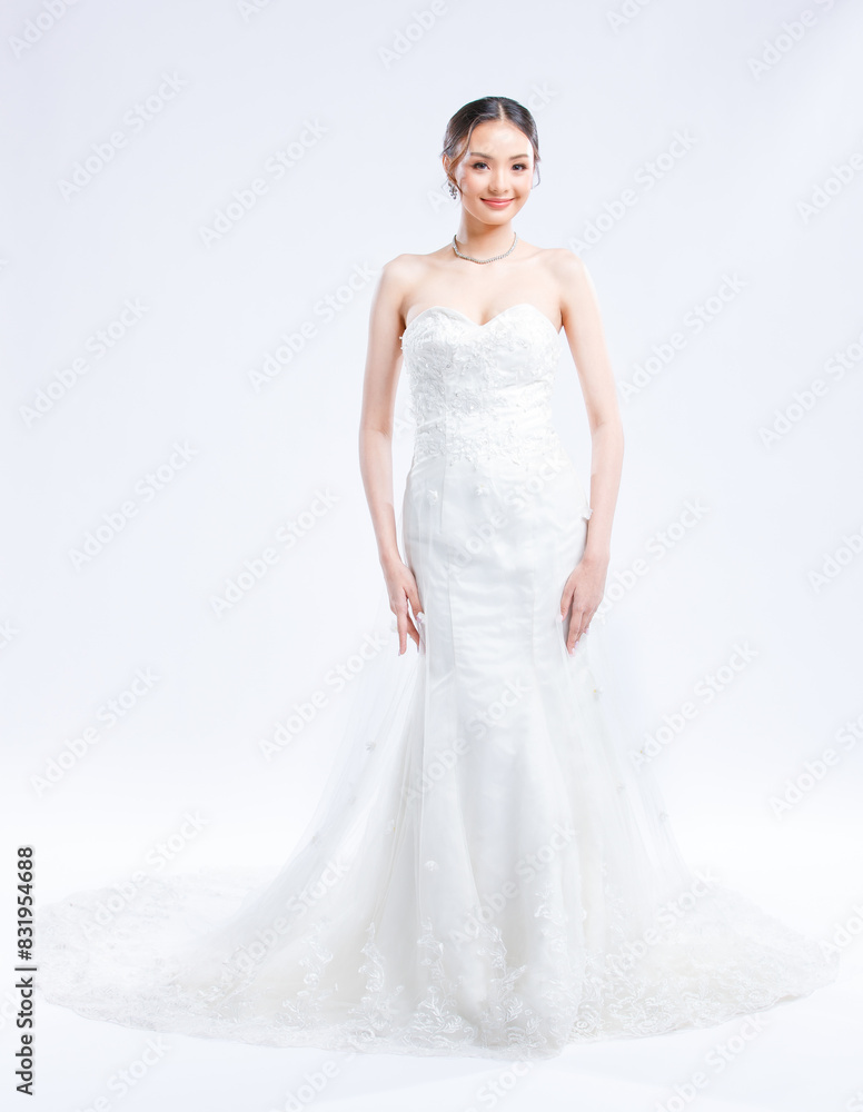 Asian young beautiful female portrait attractive model of bride wearing fashion wedding dress, luxury delight make-up, hairstyle, standing looking camera isolated white background studio indoor photo Asian young beautiful female portrait attractive model of bride wearing fashion wedding dress, luxury delight make-up, hairstyle, standing looking camera isolated white background studio indoor photo