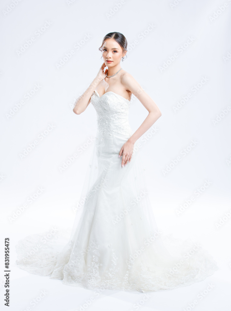 Asian young beautiful female portrait attractive model of bride wearing fashion wedding dress, luxury delight make-up, hairstyle, standing looking camera isolated white background studio indoor photo Asian young beautiful female portrait attractive model of bride wearing fashion wedding dress, luxury delight make-up, hairstyle, standing looking camera isolated white background studio indoor photo