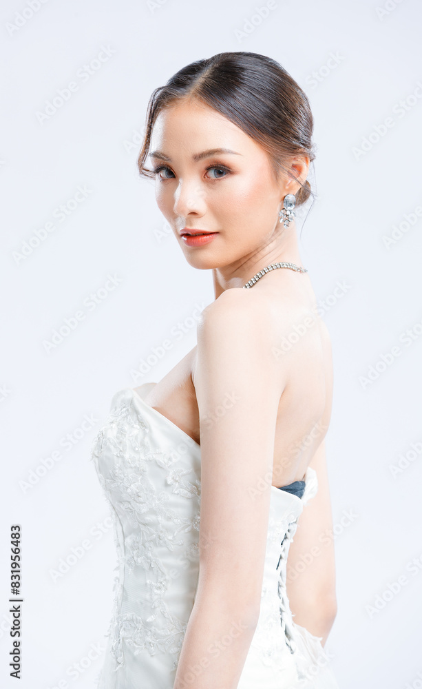 Asian young beautiful female portrait attractive model of bride wearing fashion wedding dress, luxury delight make-up, hairstyle, standing looking camera isolated white background studio indoor photo Asian young beautiful female portrait attractive model of bride wearing fashion wedding dress, luxury delight make-up, hairstyle, standing looking camera isolated white background studio indoor photo
