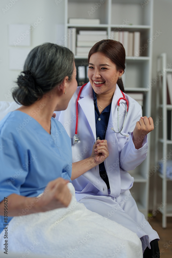 A friendly doctor talks with a retired female patient resting in bed. Full recovery after illness Doctor gives advice on health care Physical examination, treatment advice, medicine, health insurance