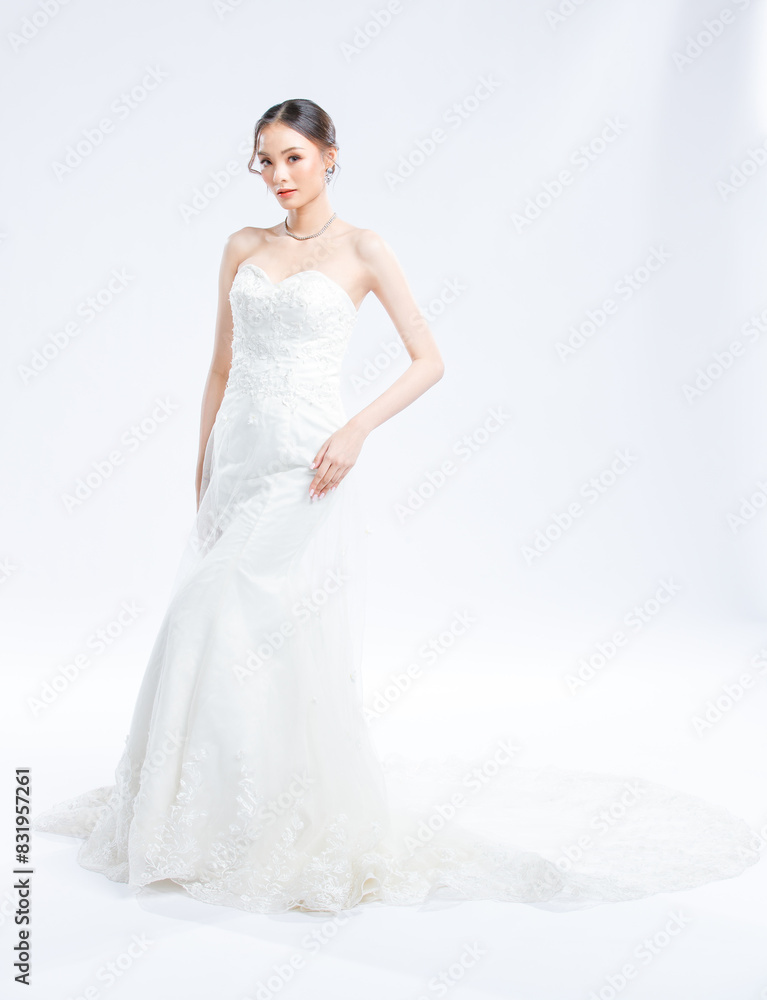 Asian young beautiful female portrait attractive model gorgeous charming bride wearing fashion wedding dress luxury perfect style, posing standing smile looking camera isolated white background studio Asian young beautiful female portrait attractive model gorgeous charming bride wearing fashion wedding dress luxury perfect style, posing standing smile looking camera isolated white background studio