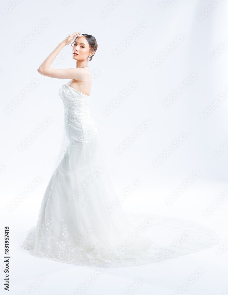 Asian young beautiful female portrait attractive model gorgeous charming bride wearing fashion wedding dress luxury perfect style, posing standing smile looking camera isolated white background studio Asian young beautiful female portrait attractive model gorgeous charming bride wearing fashion wedding dress luxury perfect style, posing standing smile looking camera isolated white background studio
