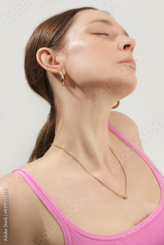 Cleavage of women with beautiful gold necklace, beautiful neck and neckline, clean skin, studio shot. 