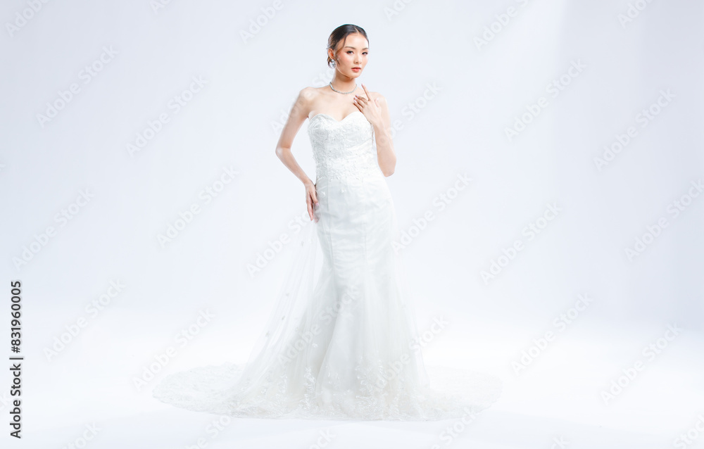Asian young beautiful female portrait attractive model of bride wearing fashion wedding dress, luxury delight make-up, hairstyle, standing looking camera isolated white background studio indoor photo Asian young beautiful female portrait attractive model of bride wearing fashion wedding dress, luxury delight make-up, hairstyle, standing looking camera isolated white background studio indoor photo