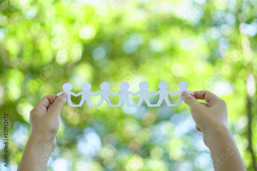 Team of business professionals holding  green sustainability icon, symbolizing their commitment to nature and sustainable practices. showcasing unity and environmental responsibility.