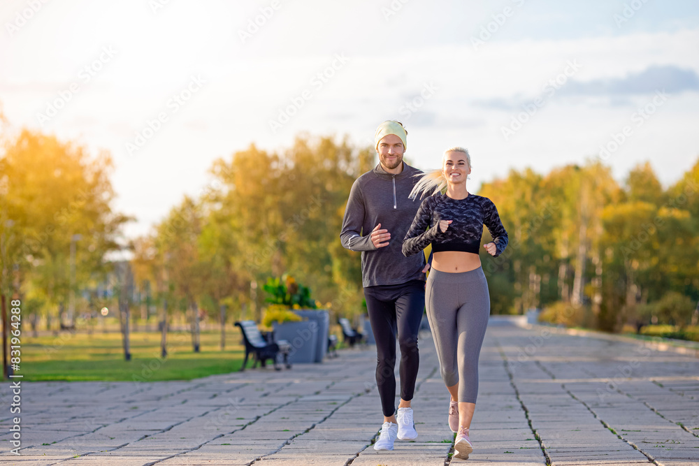 Sport Concepts. Full Length Portrait of Two Happy Runners as Couple Training Together At Running Training Fitness Exercise At Nature Outside During Training Outdoor