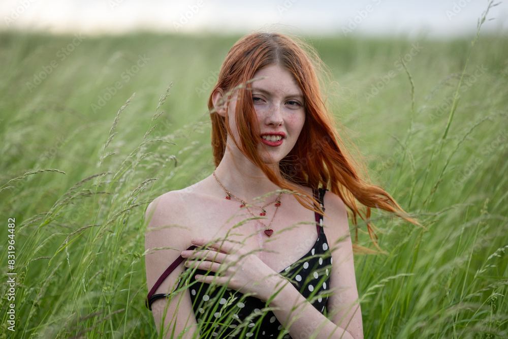Portrait of a red-haired hippie girl in a tall grass Portrait of a red-haired hippie girl in a tall grass