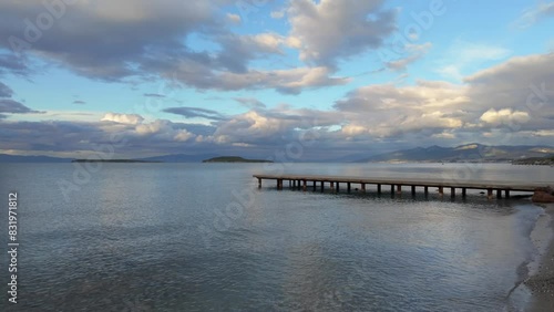 Wallpaper Mural A pier on the coast, with a cloudy sky and water stretching to the horizon. The afterglow of dusk reflects off the wind waves on the natural landscape Torontodigital.ca