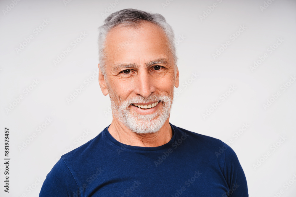Smiling senior man with beard and gray hair looking at camera, isolated on white background Smiling senior man with beard and gray hair looking at camera, isolated on white background