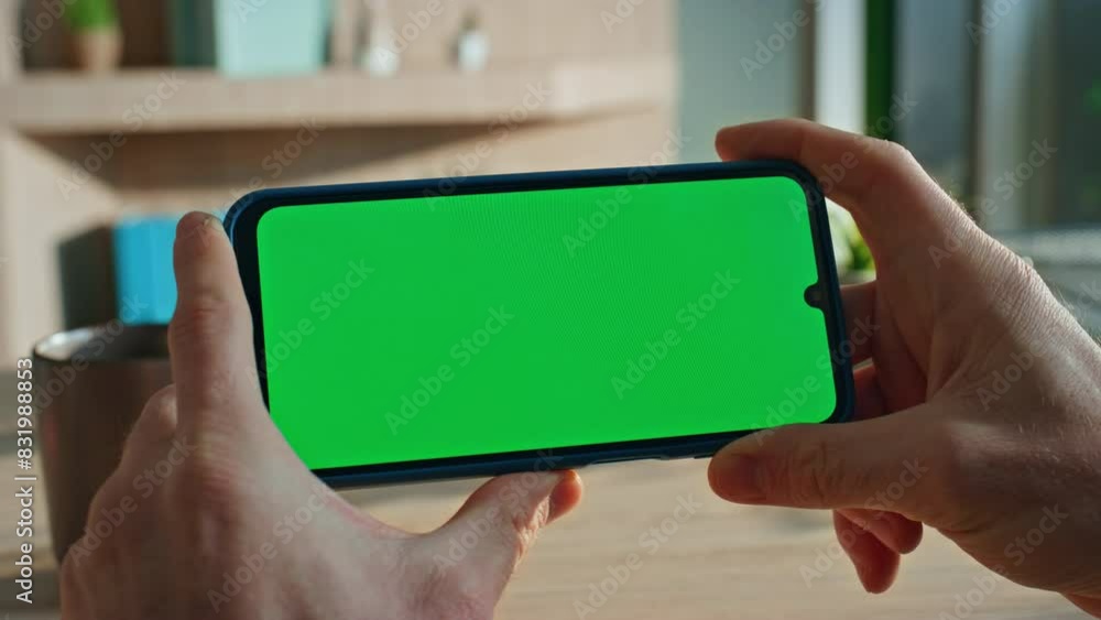 Guy watching video mockup cellphone in home apartment close up. Freelancer hands Guy watching video mockup cellphone in home apartment close up. Freelancer hands