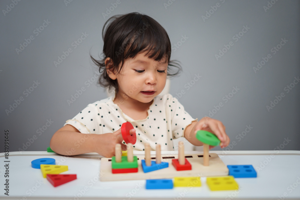 toddler baby girl playing with wooden educational geometric on table toddler baby girl playing with wooden educational geometric on table