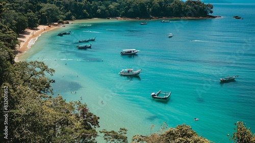 a body of blue water with several boats floating on it. The water is clear and turquoise in color. The shore is covered in trees, and a sandy beach can be seen near the water