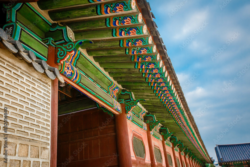 Low angle view of colorful patterned gyeongbokgung roof against sky