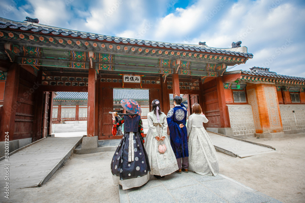 Tourists in national clothes walk in Gyeongbokgung Palace