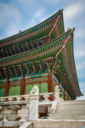 Low angle view of colorful patterned gyeongbokgung roof against sky photo