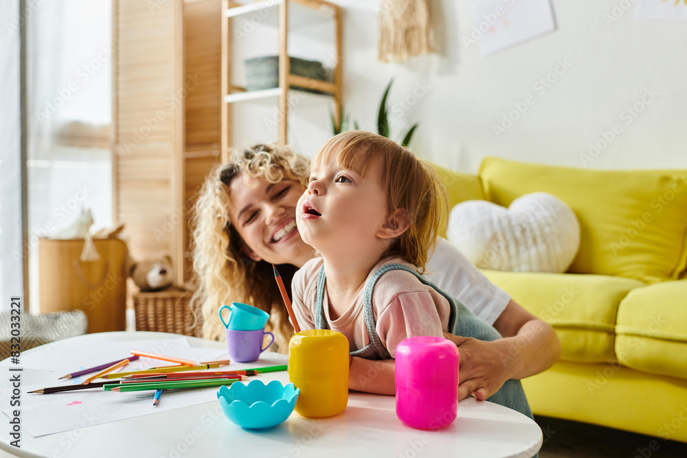 A curly-haired mother and her toddler daughter happily playing with toys in their cozy living room. A curly-haired mother and her toddler daughter happily playing with toys in their cozy living room.