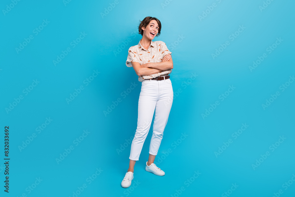 Full body portrait of nice cheerful minded lady folded hands look empty space isolated on blue color background Full body portrait of nice cheerful minded lady folded hands look empty space isolated on blue color background