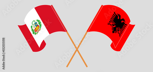 Crossed and waving flags of Peru and Albania