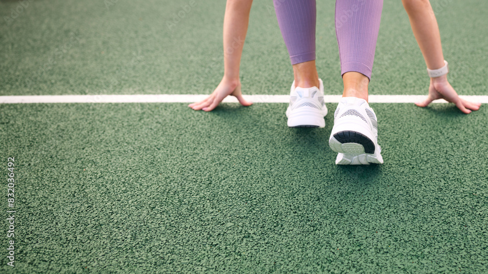 Close Up Of Female Athlete With Feet On Starting Line Before Start Of Race Close Up Of Female Athlete With Feet On Starting Line Before Start Of Race