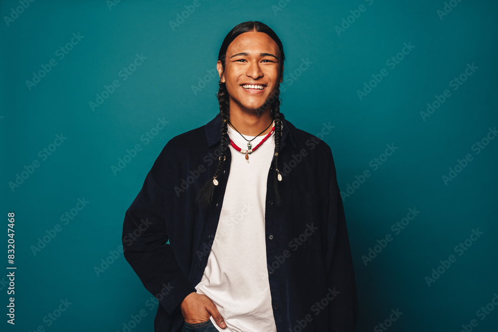 Portrait of a confident native man with braided hair and stylish jewelry Portrait of a confident native man with braided hair and stylish jewelry