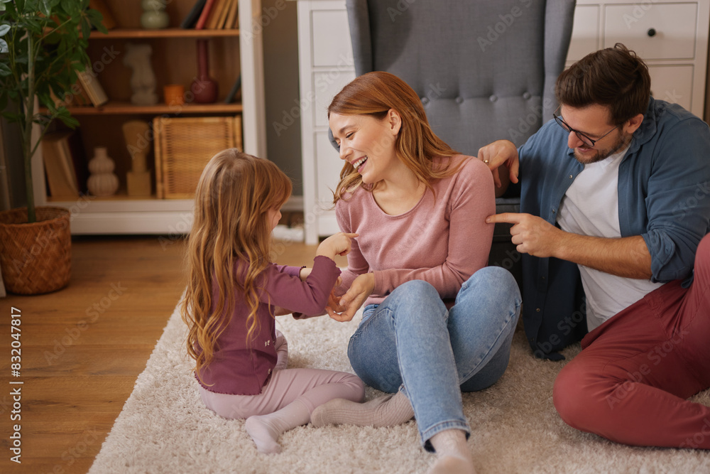 Parents having fun with their little daughter at home Parents having fun with their little daughter at home