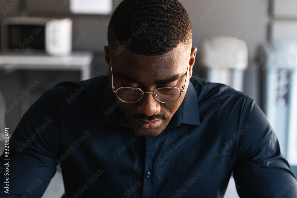 Obraz premium Portrait of a serious young black man looking down