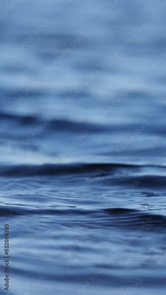 Close-up of tranquil blue water ripples. Vertical video Close-up of tranquil blue water ripples. Vertical video