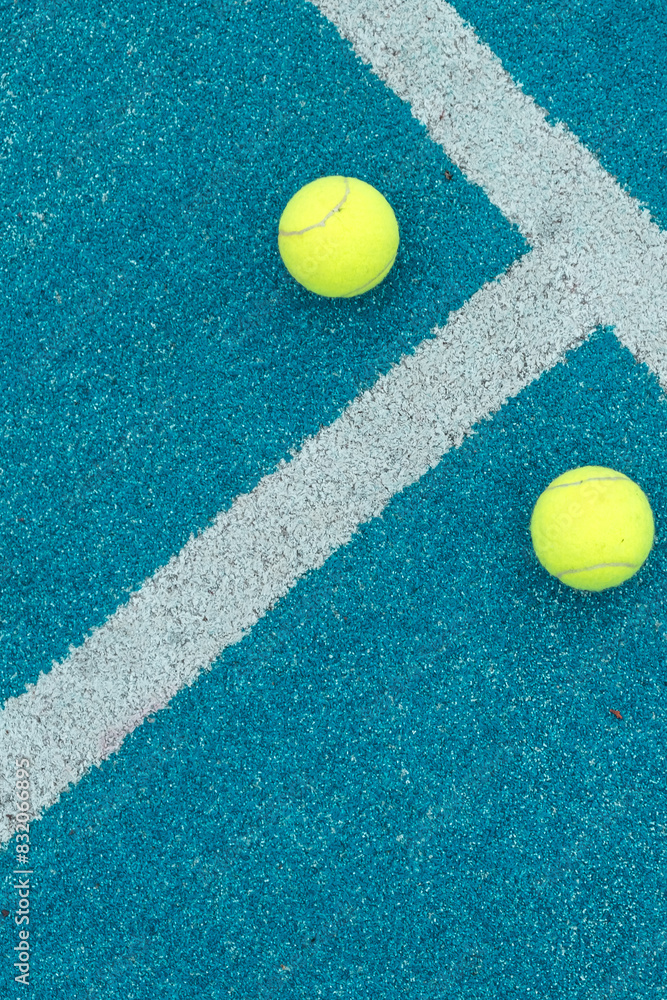 top view of two balls on a paddle tennis court
