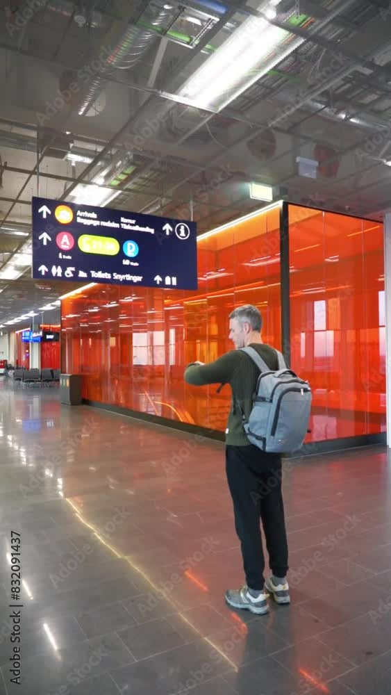 Traveler man looking at airport signs Traveler man looking at airport signs