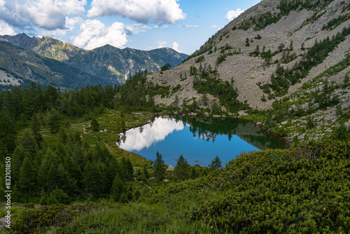 Pristine alpine lake reflecting the blue sky, Alpine Crossing, Italian Alps, Italy photo