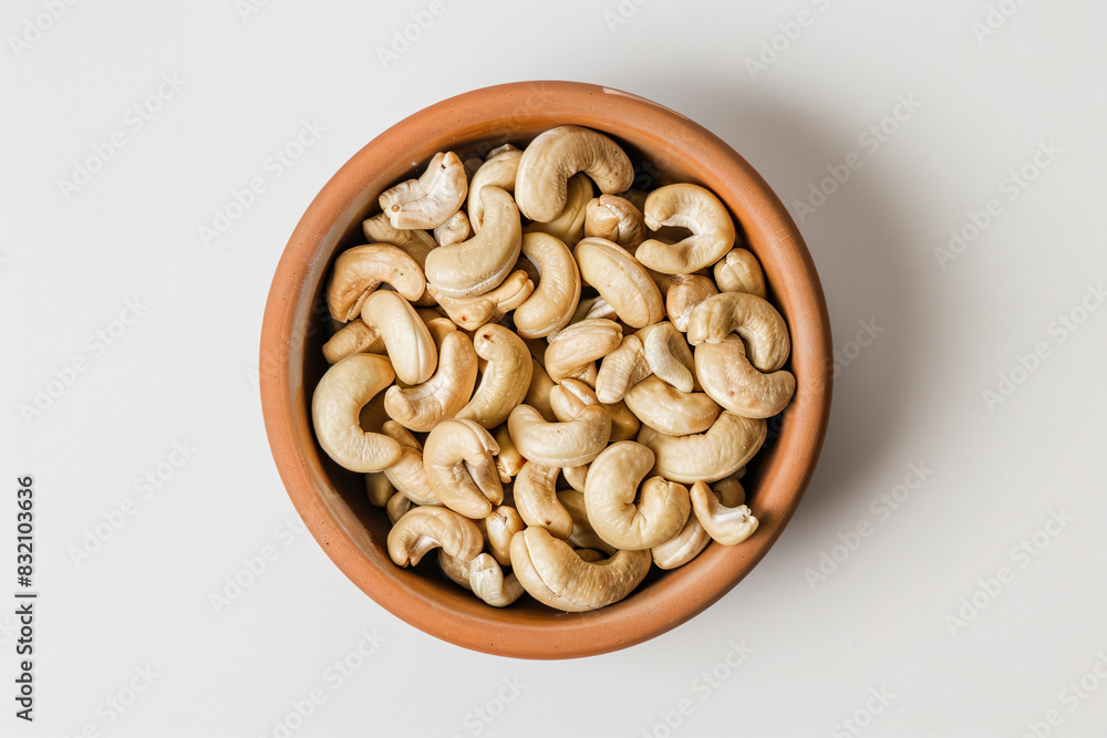 a bowl of cashews on a white surface a bowl of cashews on a white surface