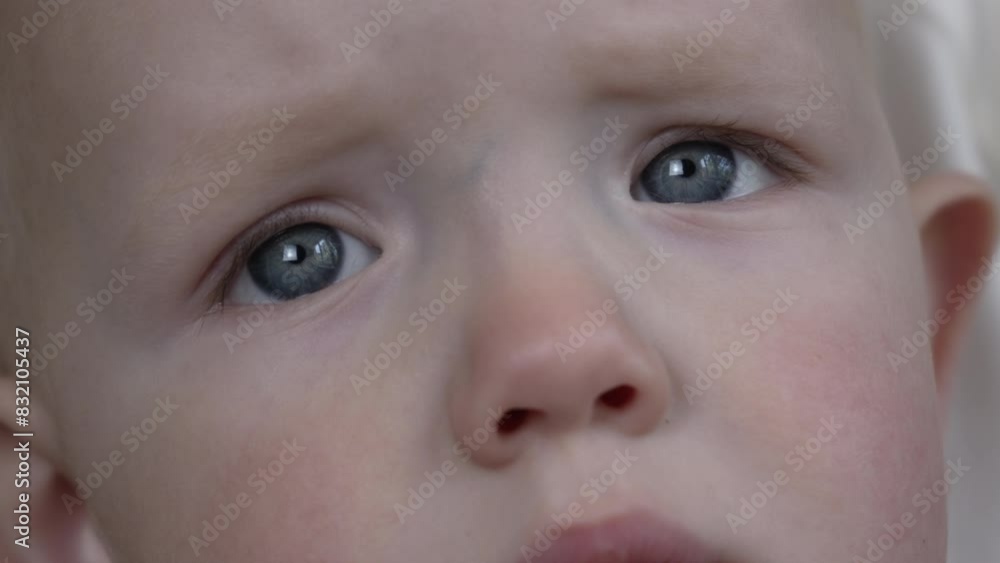 Beautiful children's gray eyes close-up. Sad look. The baby looks up sadly. High quality 4k footage Beautiful children's gray eyes close-up. Sad look. The baby looks up sadly. High quality 4k footage