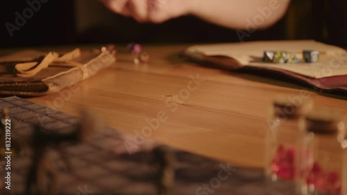A person playing a tabletop roleplaying game with dice and miniatures