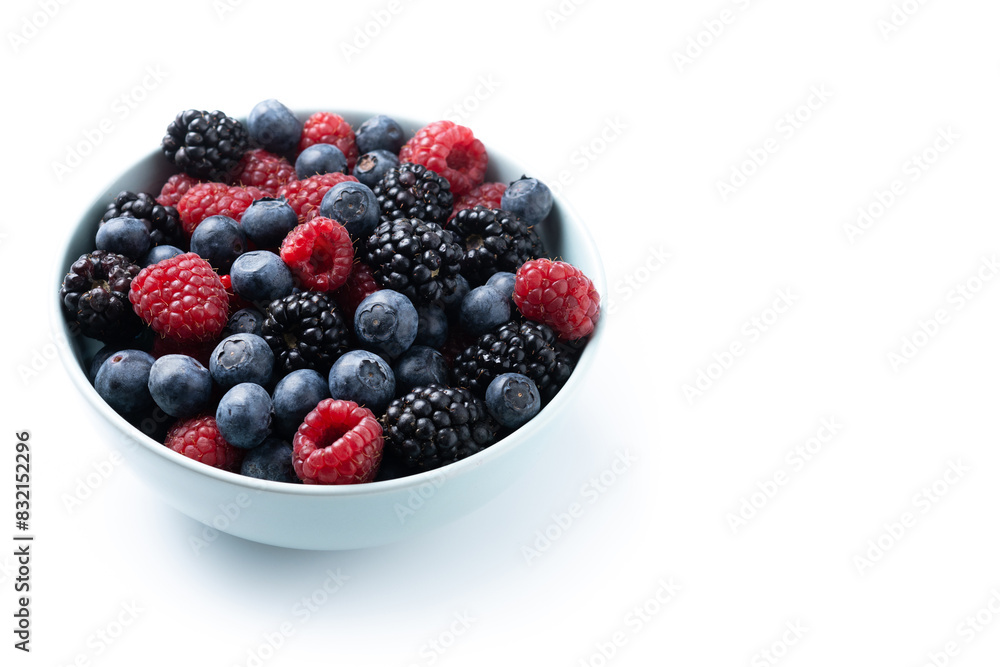 Fresh assortment berries in bowl isolated on white background. Copy space Fresh assortment berries in bowl isolated on white background. Copy space