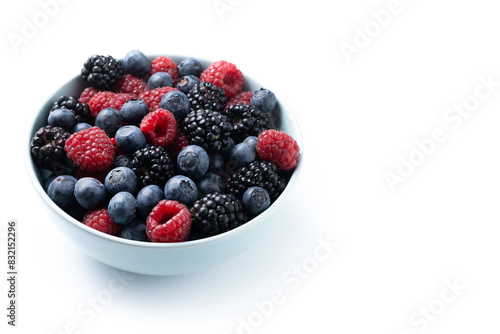 Fresh assortment berries in bowl isolated on white background. Copy space