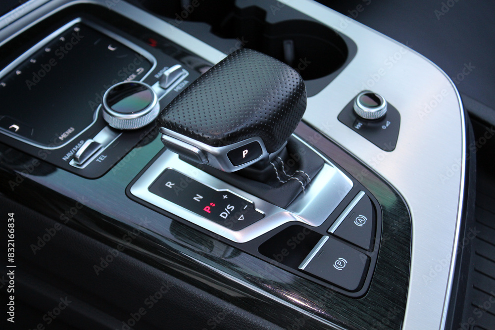 Close up car automatic transmission. Gear shift in new electric car. Selector automatic transmission with leather in the interior of a new modern car. Car Black leather interior. Close up car automatic transmission. Gear shift in new electric car. Selector automatic transmission with leather in the interior of a new modern car. Car Black leather interior.