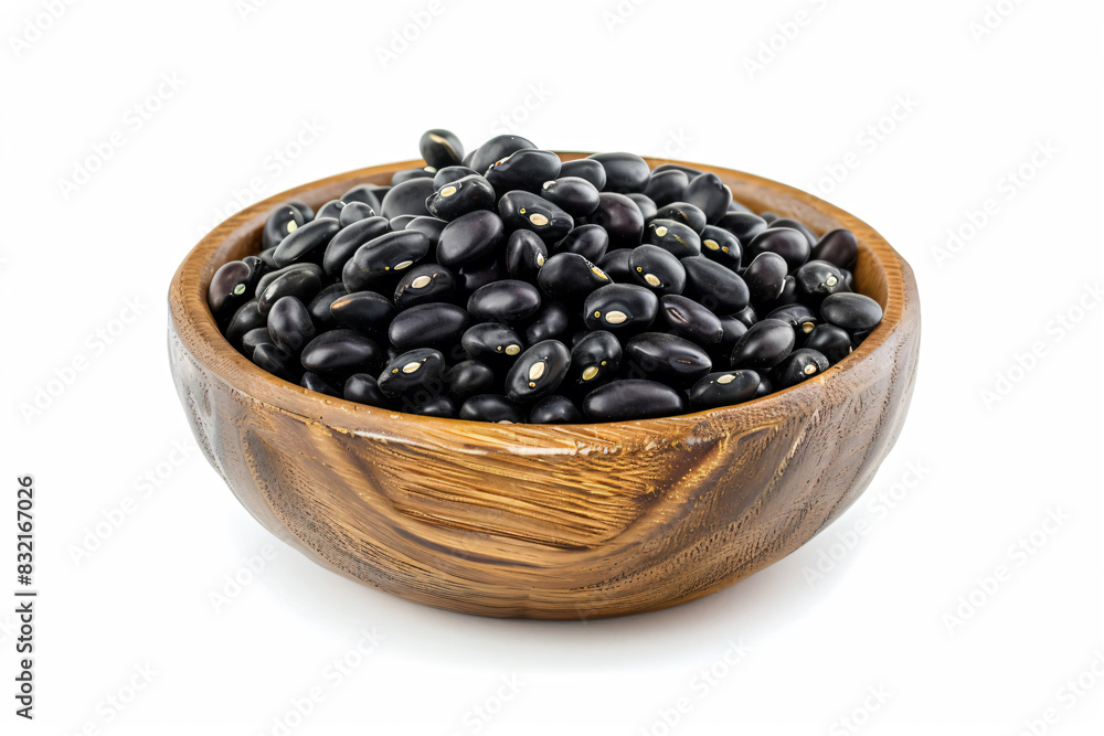 a wooden bowl filled with black beans on a white surface a wooden bowl filled with black beans on a white surface
