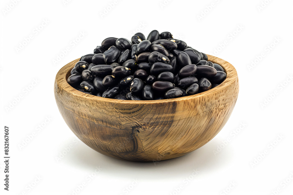 a wooden bowl filled with black beans on a white surface a wooden bowl filled with black beans on a white surface