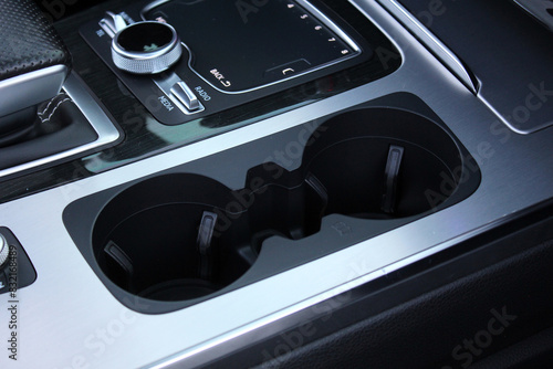 Close up cup holders and Selector automatic transmission. Cup holders inside modern car interior. Car inside.