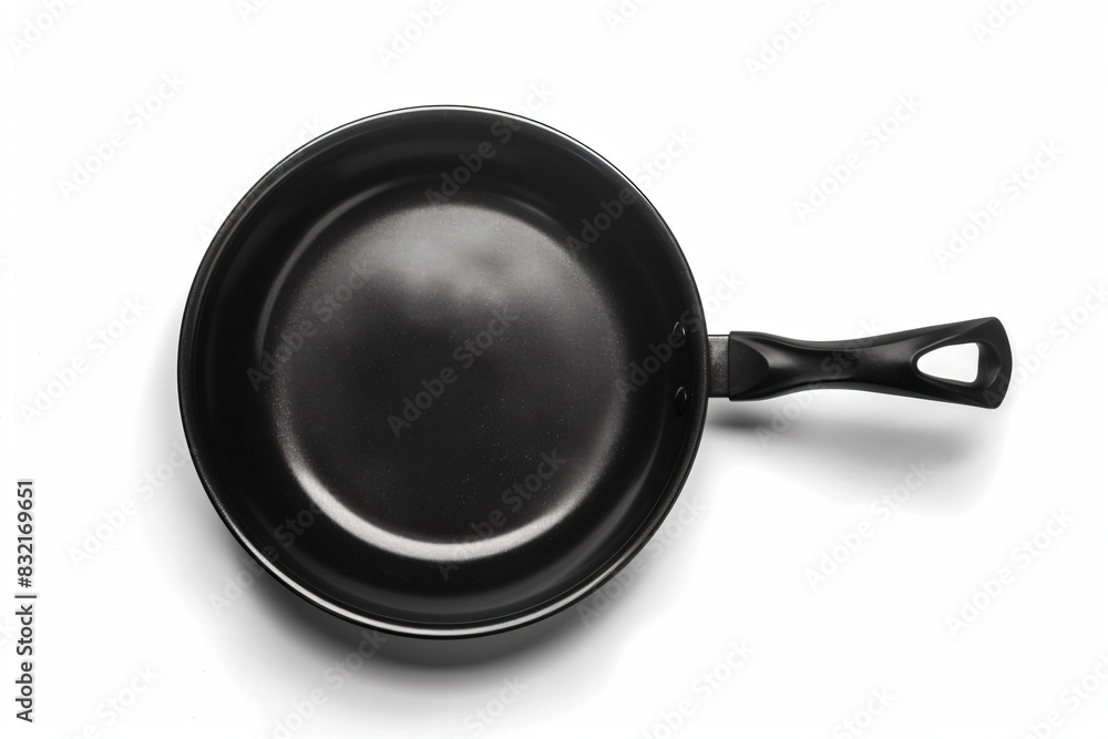 a black frying pan on a white surface a black frying pan on a white surface